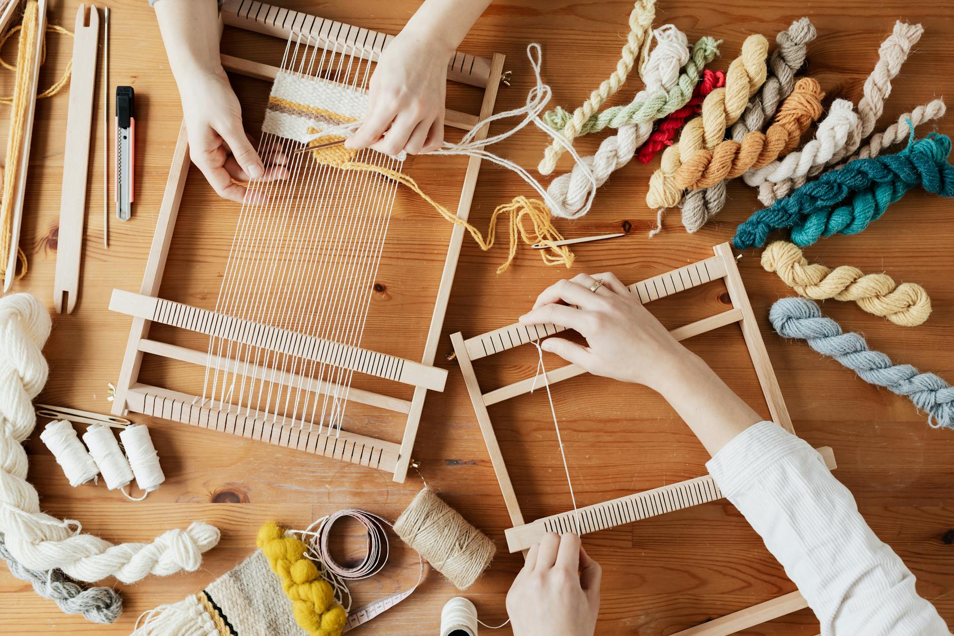 top view photo of two person s hands weaving